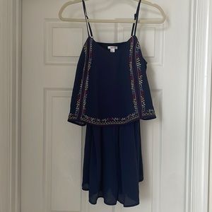 Blue romper with multi-colored detailed trim. Size large.